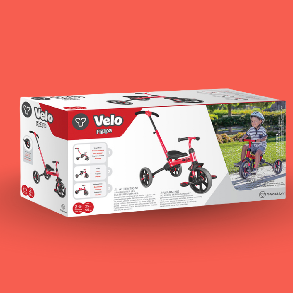 Box of a Velo children's tricycle on an orange background