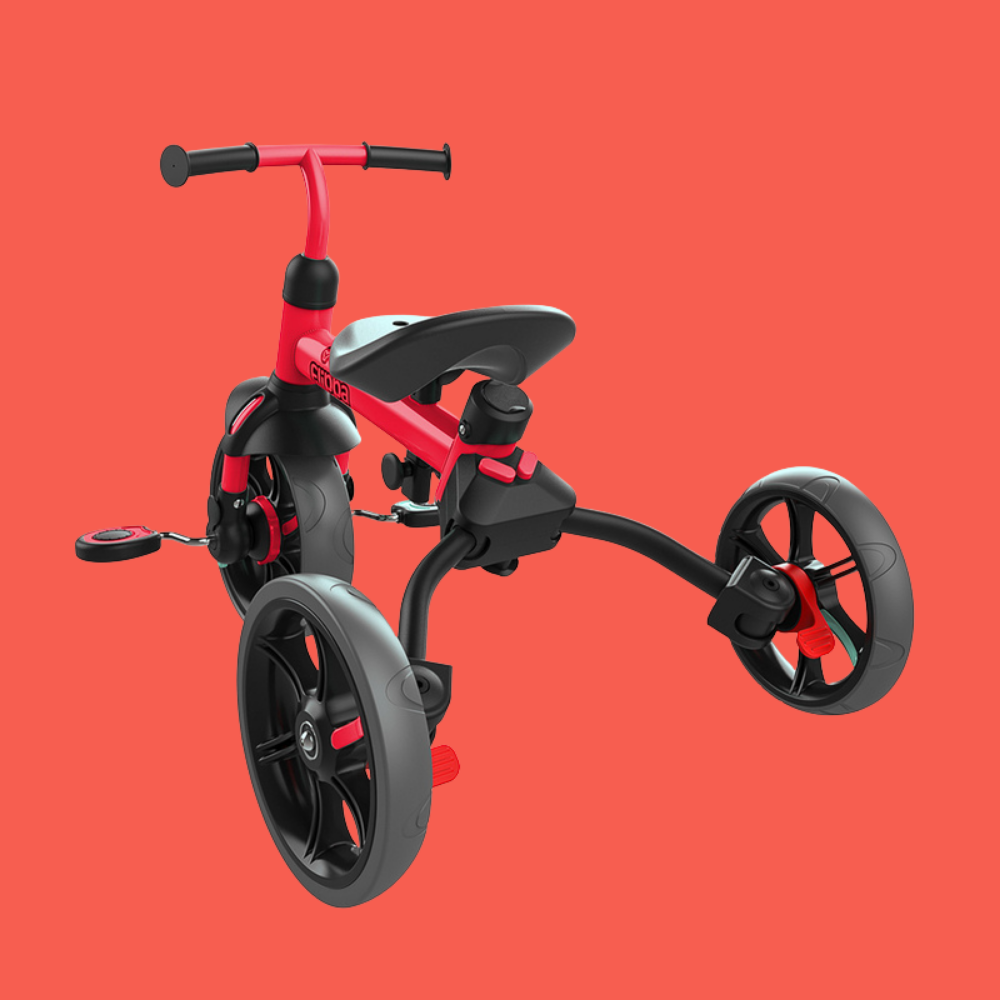 Red and black children's tricycle on a red background