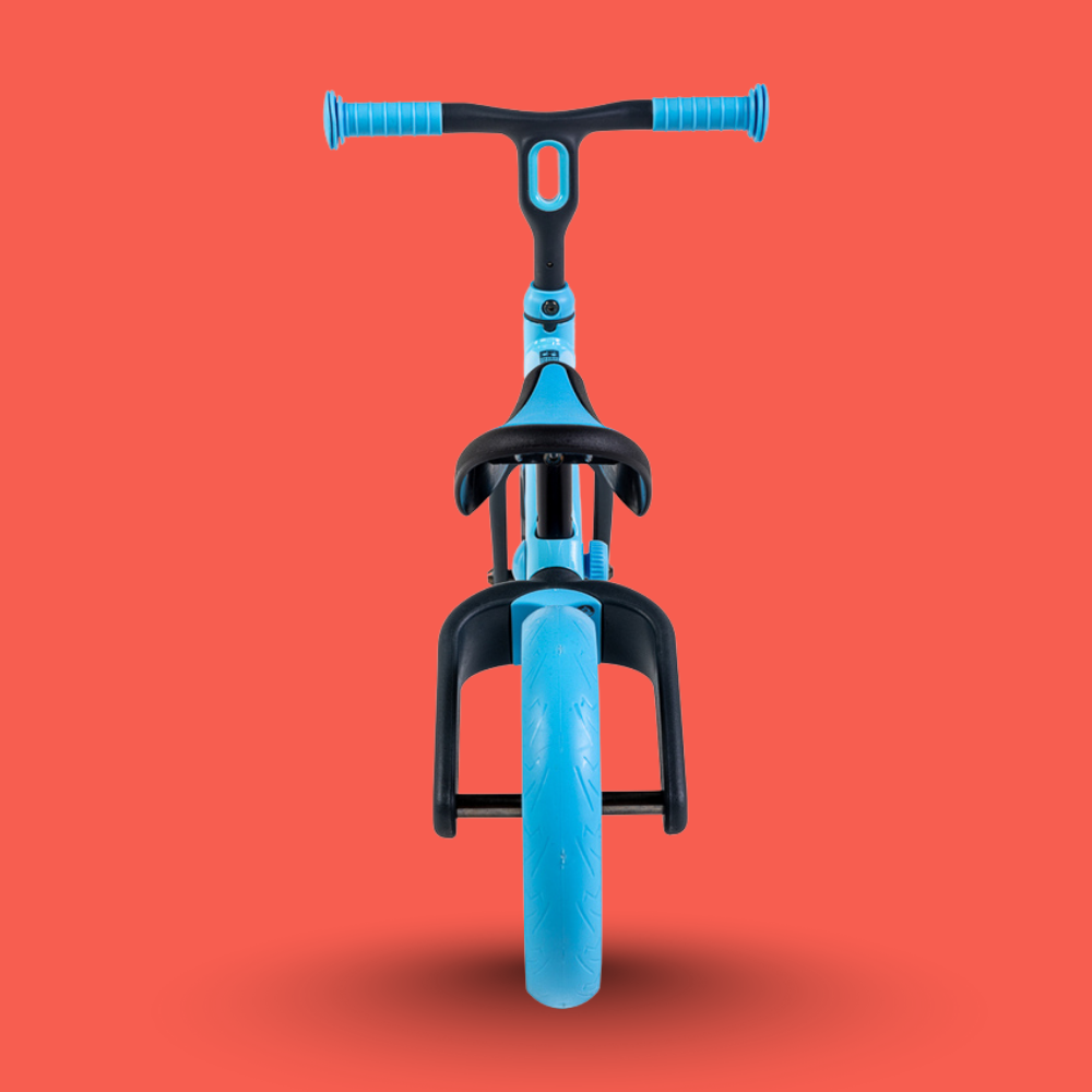 Blue balance bike with black handlebar and seat on a red background