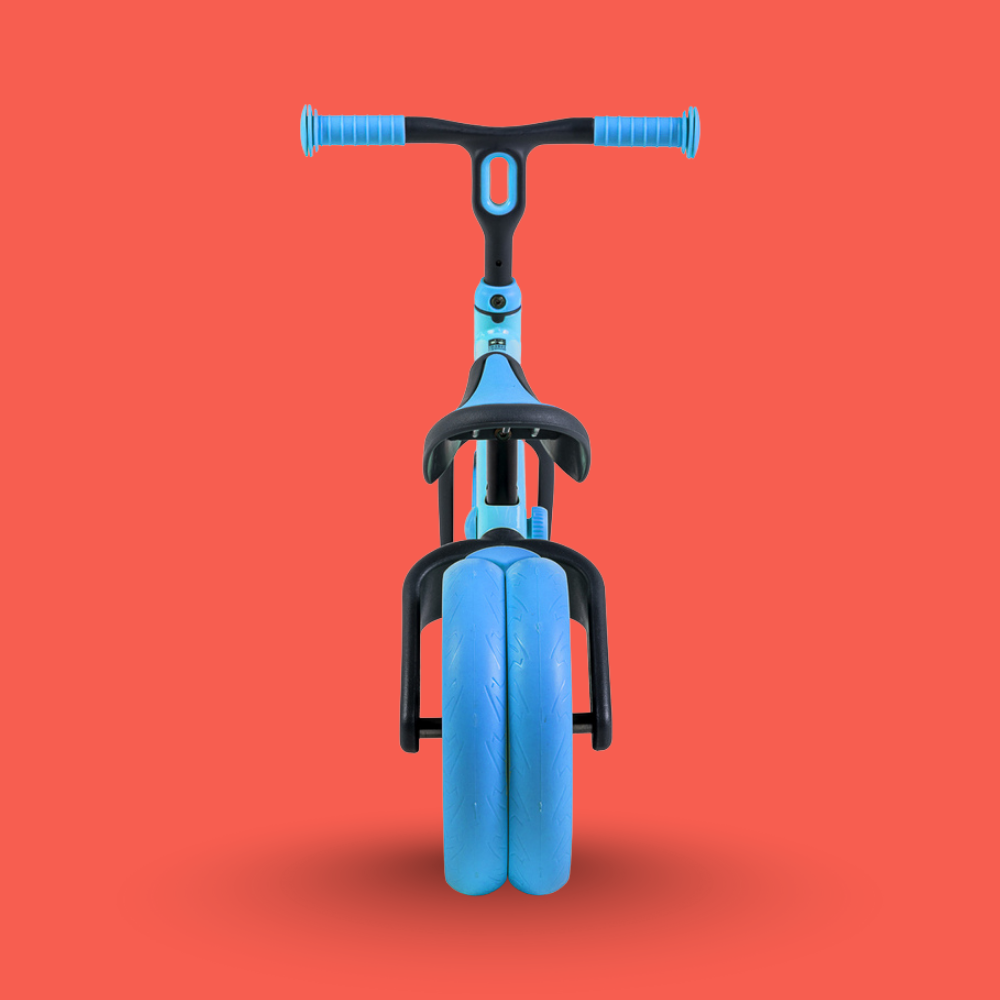 Blue balance bike with black accents on a red background