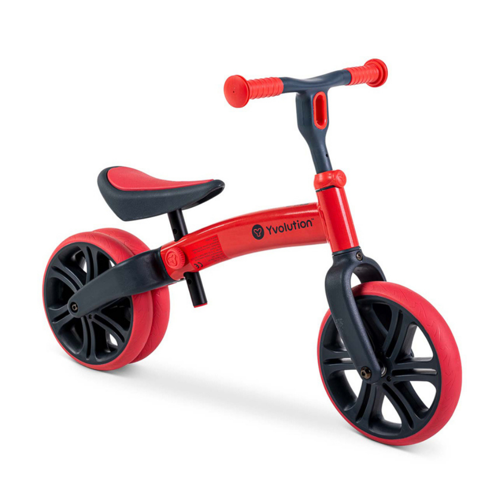 Red and black balance bike on a white background
