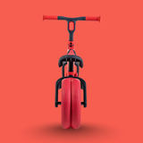 Red unicycle with black handlebar on a red background
