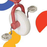 Toy tricycle with colorful abstract shapes in the background