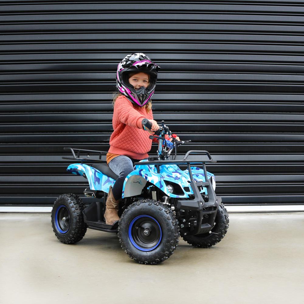 girl riding the blue atv on a sunny day