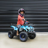 girl riding the blue atv on a sunny day