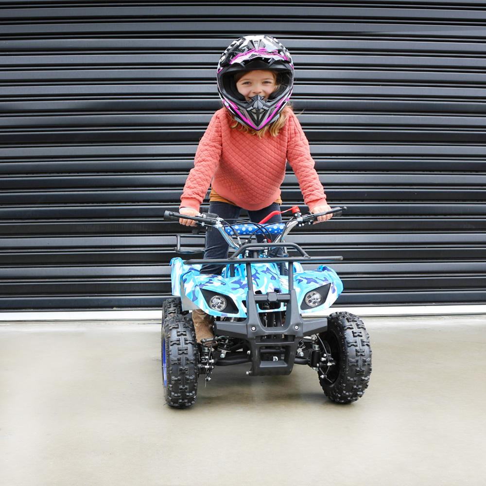 girl wearing a safety riding helmet while riding on a blue ATV