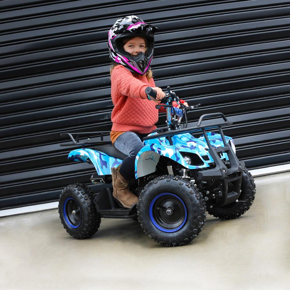 MJM 49cc Petrol Powered side view with a girl wearing a helmet riding on the blue ATV